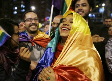 People celebrate in a park as they listen to the announcement from Havana, Cuba, that a peace deal has been reached.