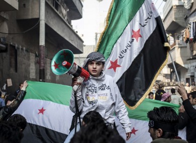 A child uses a megaphone to chant Free Syrian Army slogans during a demonstration in 2013.