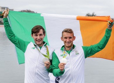 Paul and Gary O'Donovan celebrate with their silver medals.