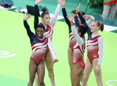 USA's Simone Biles (left) and team-mates celebrate winning gold in the Women's Gymnastics Team Final at the Rio Olympic Arena on the fourth day of the Rio Olympic Games.