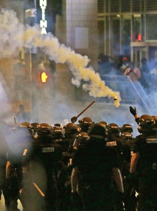 Police fire tear gas early this morning, as protestors converge in Charlotte, North Carolina, after Tuesday's police shooting of Keith Lamont Scott.