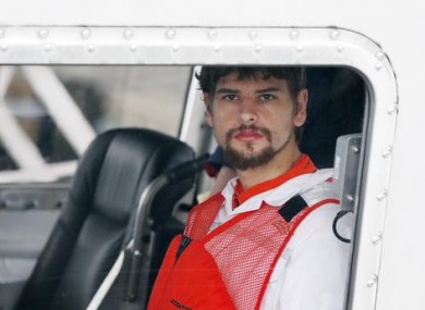 Nathan Carman arrives in a small boat at the US Coast Guard station on Tuesday in Boston after spending a week at sea.