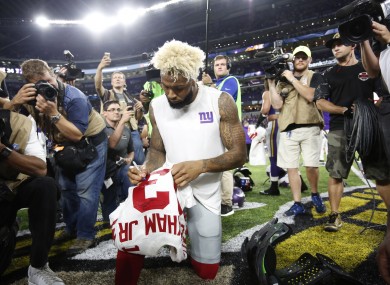 New York Giants wide receiver Odell Beckham autographs his jersey after an NFL football game against the Minnesota Vikings.