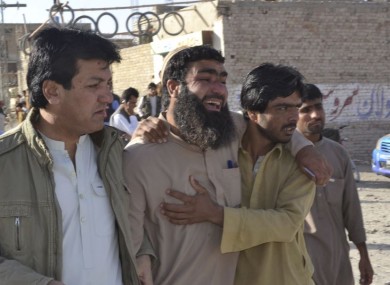 Family members of victims visit a police training centre where gunmen opened fire in Quetta.