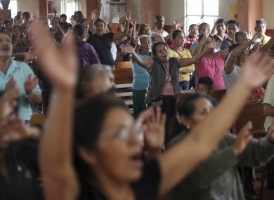 Parishioners celebrate after the news that Rev. Jose Luis Sanchez Ruiz has been found alive, at a his church in Catemaco