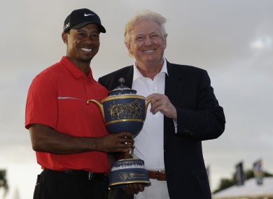 Tiger Woods stands with Donald Trump as he holds the Gene Serazen Cup for winning the Cadillac Championship golf tournament in 2013.