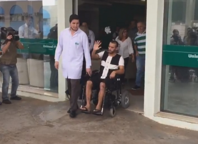 Chapecoense survivor Alan Ruschel waves to the crowd as he leaves hospital.