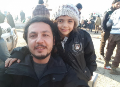 An IHH aid worker picture with Bana.