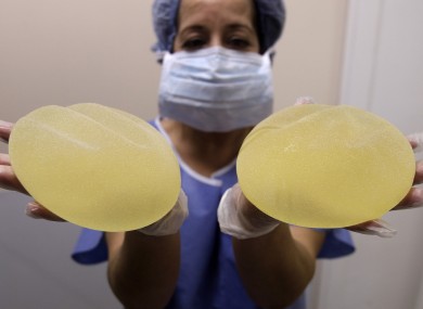 A nurse holds defective breast implant manufactured by French company Poly Implant Prothese (PIP), which were removed from a patient by a plastic surgeon.