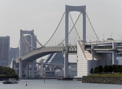A ferry goes by the Rainbow Bridge in Tokyo. 
