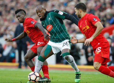 Liverpool's Sheyi Ojo (left) battles for the ball with Plymouth Argyle's Paul Arnold Garita (centre) during the Emirates FA Cup, Third Round match at Anfield.