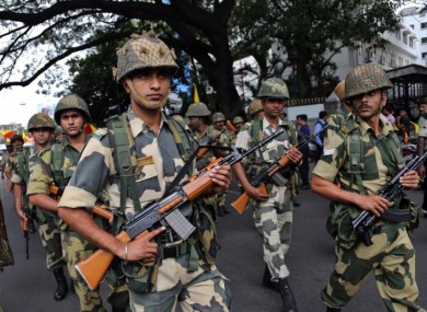 Indian soldiers keep vigil on a street during a protest against the rape of a six-year-old in Bangalore in 2014.