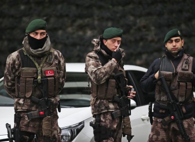 Turkish police officers stand guard at Istanbul's headquarters prior to a news conference regarding the arrest.