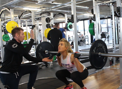 Gareth Barry guides a client through the perfect squat technique.