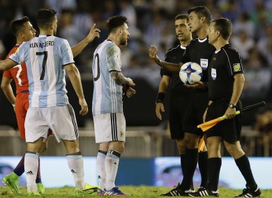 Messi arguing with referee Sandro Ricci and his assistants.