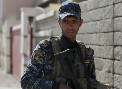 A federal policeman advances during fighting against Islamic State militants, in western Mosul