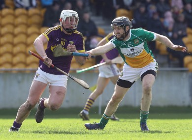 James Mulrooney and Aaron Maddock battle for possession.