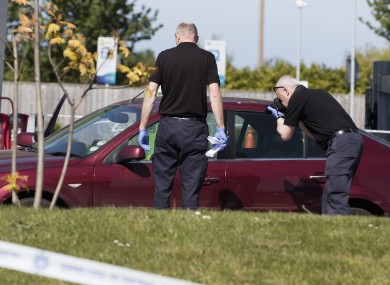 Gardaà examine Gatley's car after the shooting.