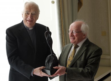 President Michael D Higgins iss presented with the Father Aengus Finucane Award for Services to Humanity by Concern Worldwide by Father Jack Finucane.