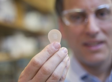 Prof Mark Prausnitz of Georgia Tech holds a microneedle patch.