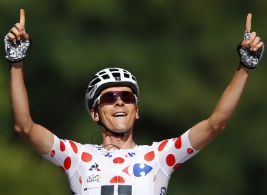 Barguil celebrates crossing the line.