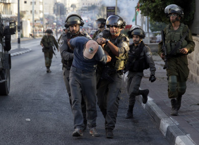 Israeli border police officers detain a Palestinian demonstrator during a protest against the metal detectors placed at the entrance to the Al Aqsa Mosque compound, in the West Bank city of Bethlehem.