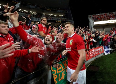 Lions' Owen Farrell poses for a picture with fans after the game.