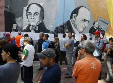 People line-up to enter to a poll station during the election for a constitutional assembly in Caracas, Venezuela.