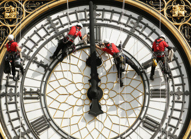 File photo dated 18/08/14 of a specialist technical abseil team cleaning and inspecting one of the four faces of Big Ben.