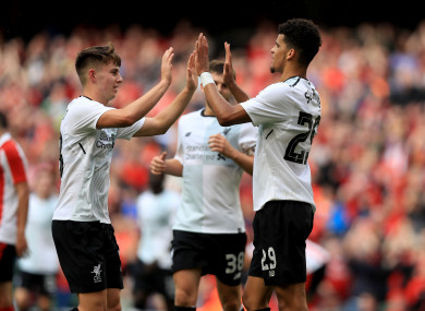 Dominic Solanke celebrates scoring his side's third goal with Ben Woodburn.