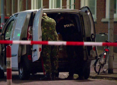 Police officers examine a van behind a cordoned-off area in Rotterdam last night.
