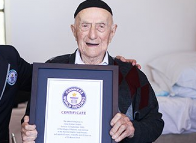 Yisrael Kristal receives his certificate last year for being the world's oldest man.