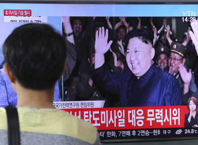 A man watches a TV news program showing an image of North Korean leader Kim Jong un during the North's latest test launch of an intercontinental ballistic missile, at Seoul Railway Station in Seoul, South Korea.