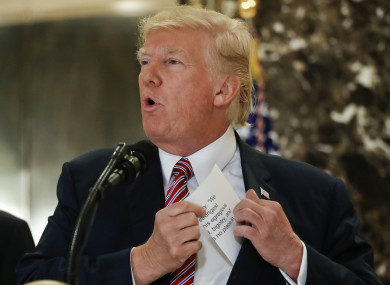 President Donald Trump reaches into his suit jacket to read from a prepared speech.