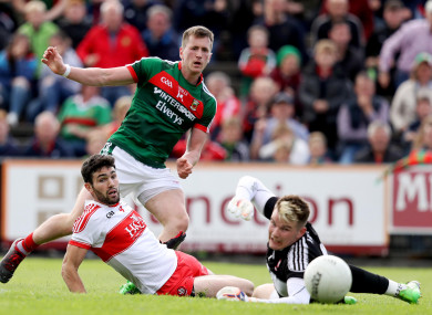 Cillian O'Connor sees a shot saved by Derry goalkeeper Ben McKinless.