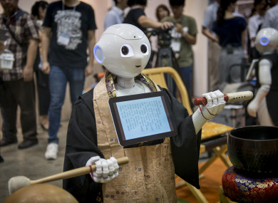 'Pepper' - the human-shaped robot while celebrating the Buddhist funeral rites to the Tokyo Int'l Funeral and Cemetery Show in Tokyo.