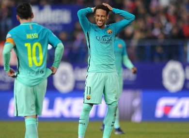 Neymar (R) reacts with Lionel Messi during a Barcelona match
