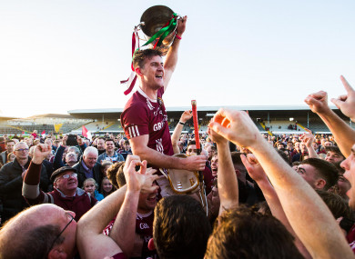 Dicksboro's Ollie Walsh celebrates after the game with the trophy.