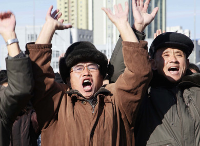People cheer on the announcement of the successful test.