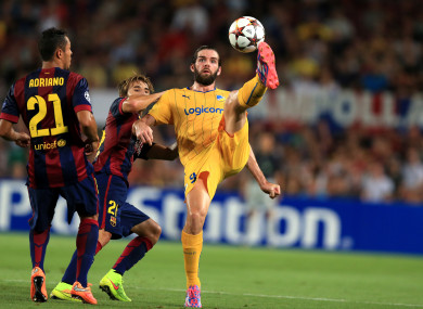 Cillian Sheridan, then of Apoel Nicosia, controls the ball despite the attentions of Barcelona's Sergi Samper during their 2014 Champions League game at the Nou Camp.