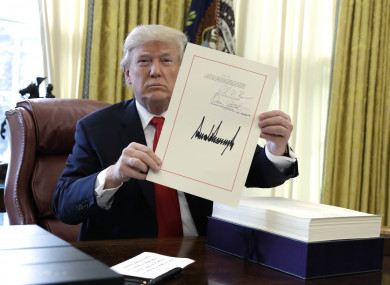 President Donald Trump signs a $1.5 trillion tax overhaul package