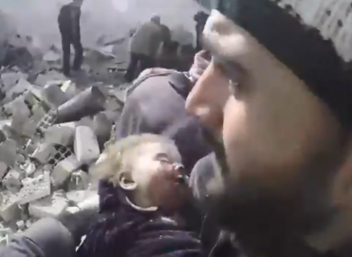 The infant was rescued from rubble in Douma city.