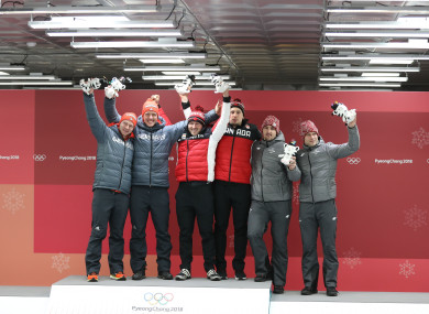 Gold medalists Germany's Johannes Lochner and Christopher Weber, Canada's Justin Kripps and Alexander Kopacz, bronze medalists Latvia's Oskars Melbardis and Janis Strenga (L to R) pose for photos.