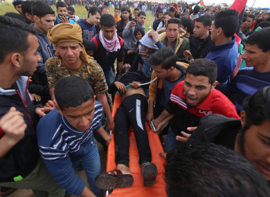 A wounded Palestinian is evacuated during clashes with Israeli troops near the Gaza-Israel border.