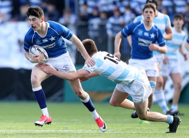 Ruairi Shields is tackled by Blackrock's Stephen Madigan.