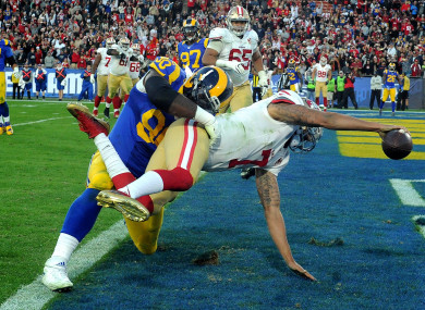 Colin Kaepernick scores during one of his last games in the NFL in December 2016.