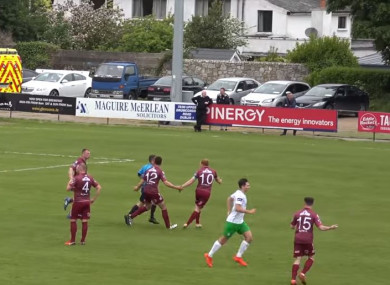 Galway United players confront the referee after the goal.