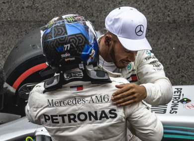 Hug it out: Hamilton and Bottas celebrate.