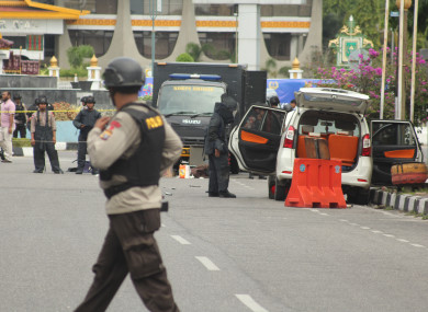 Police searching the attackers' vehicle for bombs.
