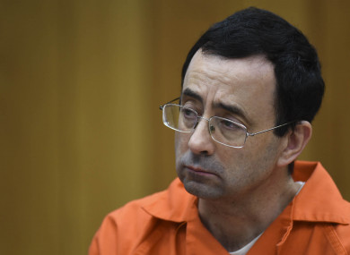 Larry Nassar listens as Rachael Denhollander gives her victim impact statement.